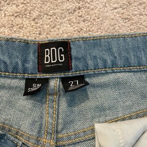 Slim straight, blue jeans, light wash, ripped with intentional bleach accents